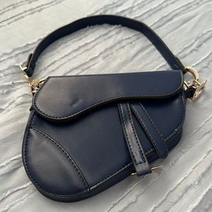 Small dark blue shoulder bag.